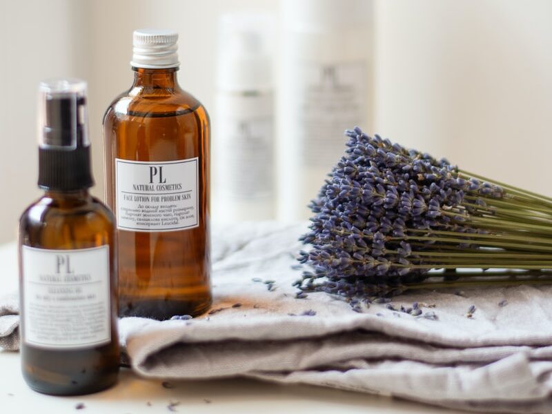lavender flower beside oil bottle