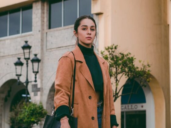 Woman in a Brown Coat Posing in City 