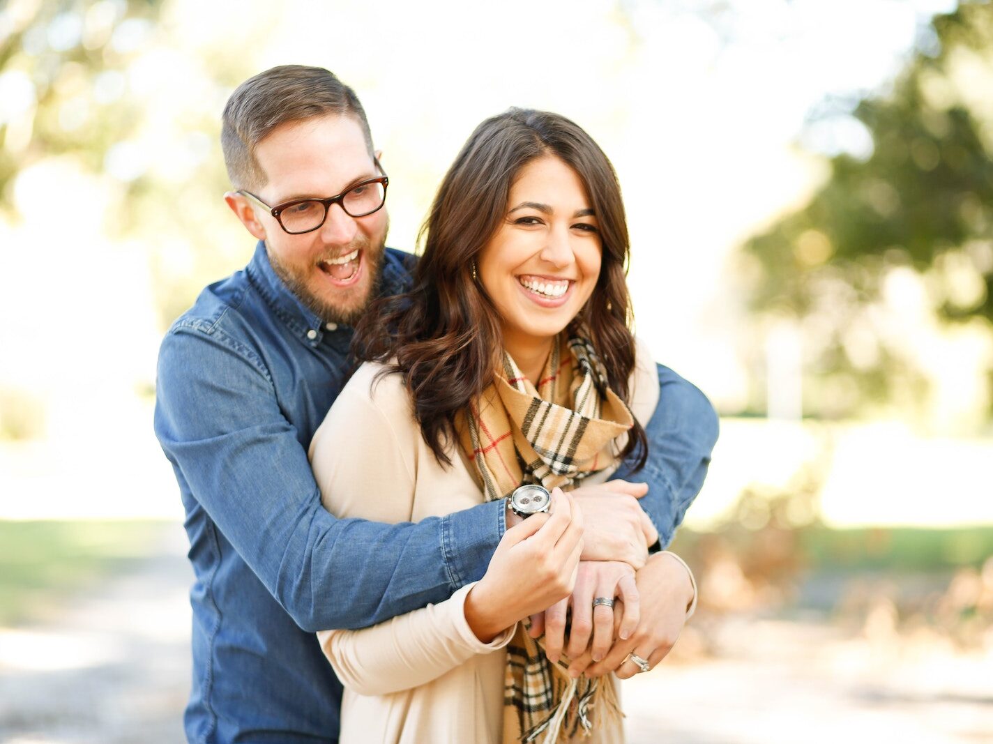Portrait of Happy Young Woman Using Mobile Phone in City