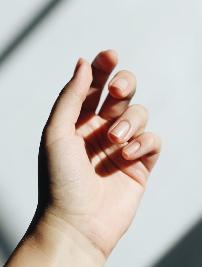 persons left hand on white table