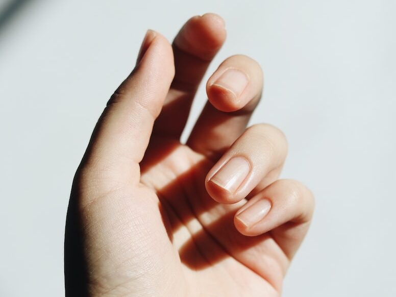 persons left hand on white table
