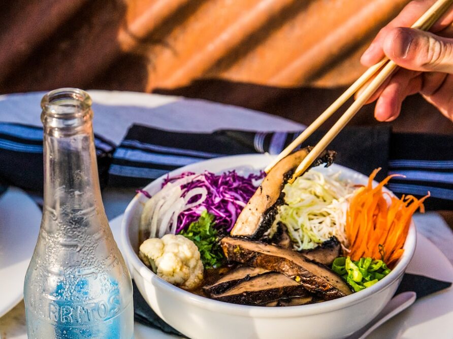 2 blue glass bottles on white table
