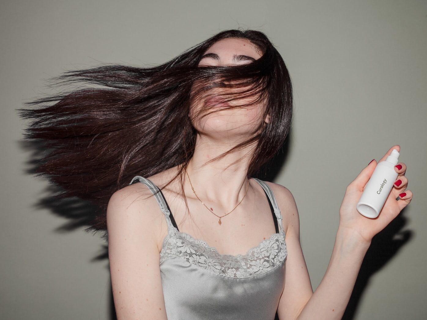 woman holding spray bottle