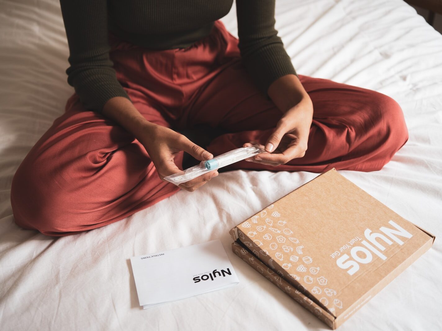 woman in red dress holding white pen