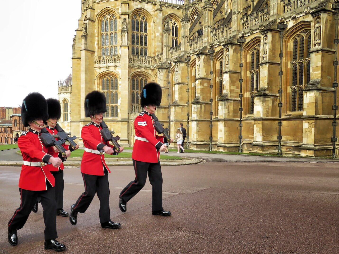 four Royal Guards marching outside palace