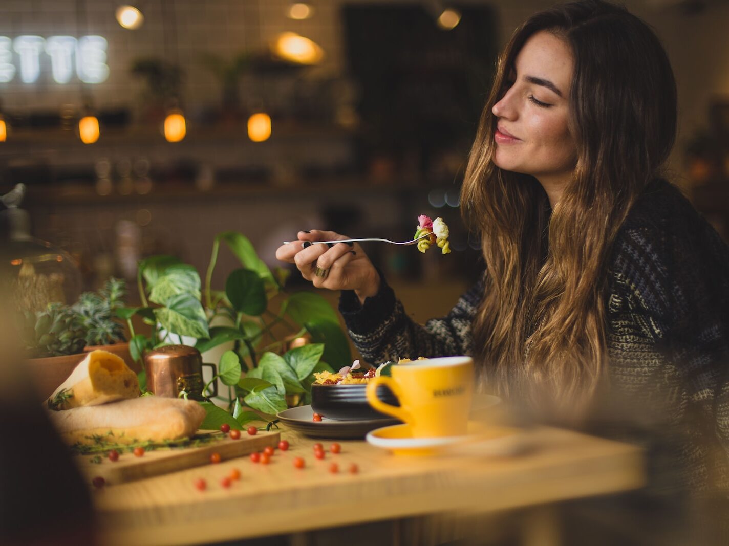 woman holding fork in front table