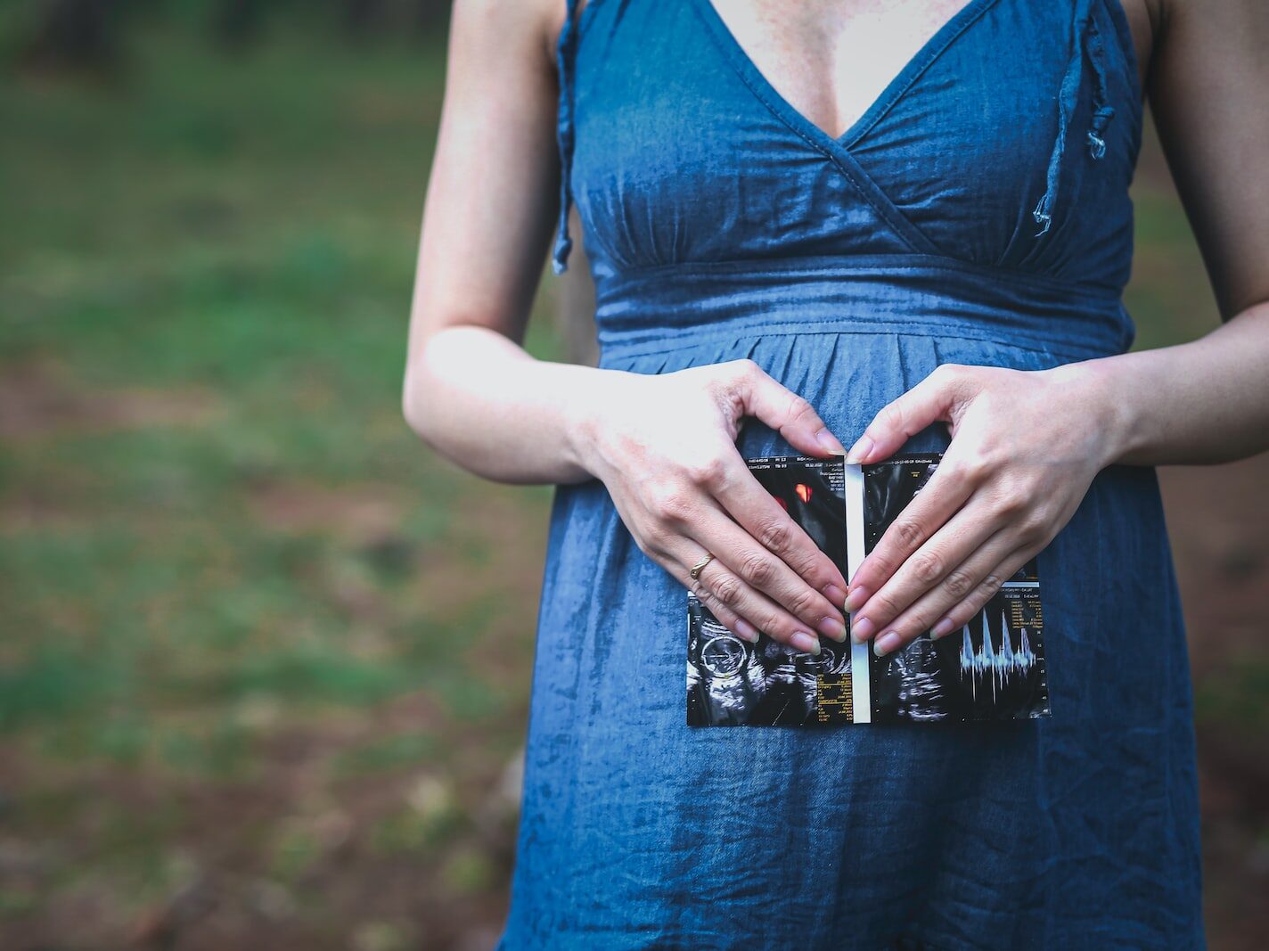 pregnant woman holding her tummy