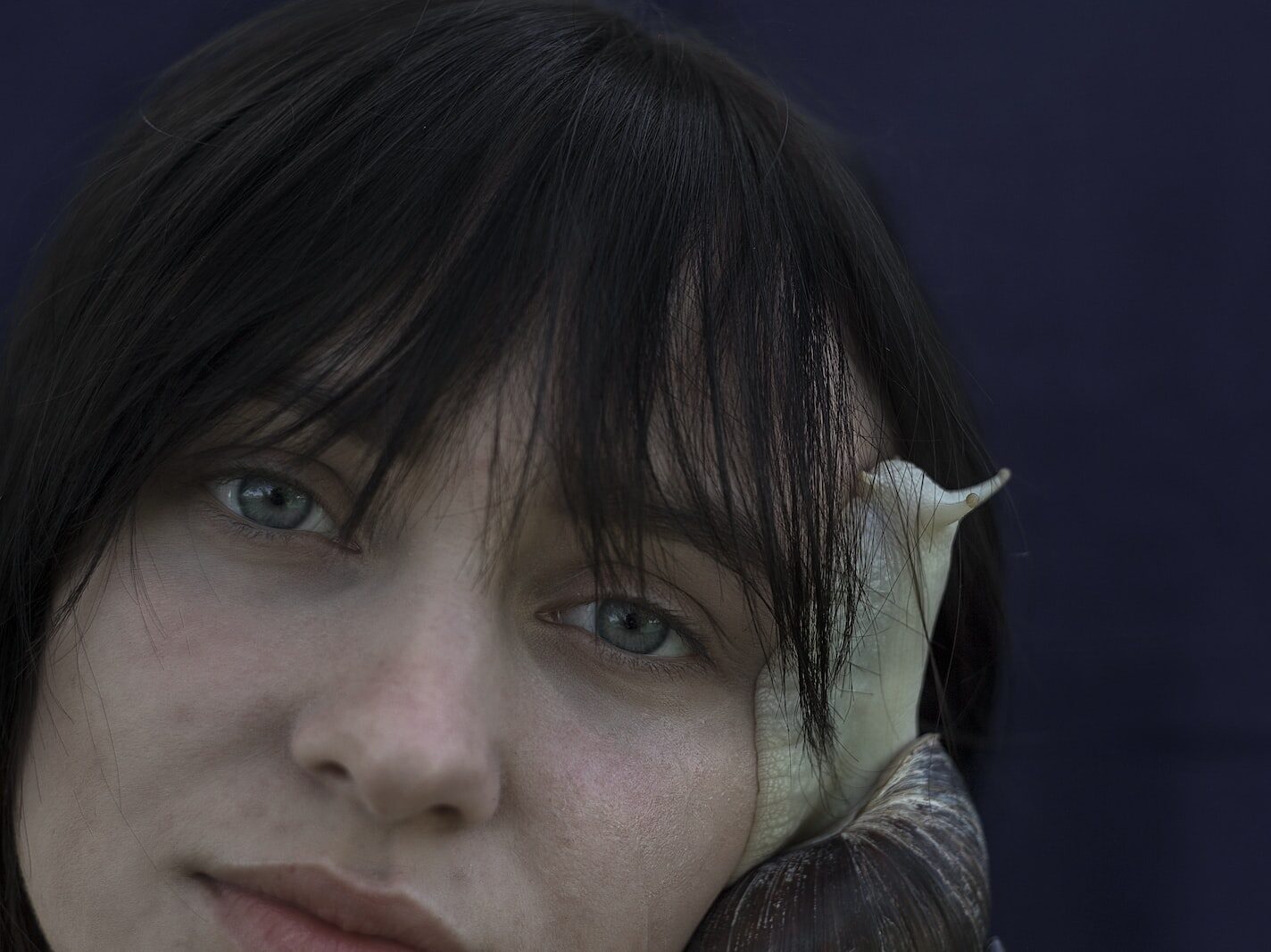 snail crawling on womens face