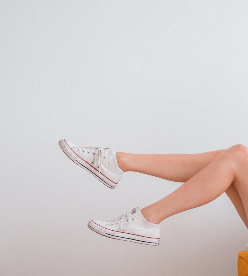 woman in white low top sneakers