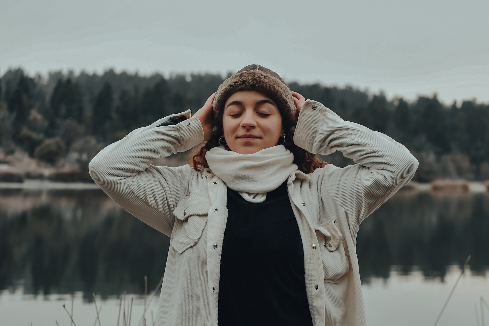 A Woman in Corduroy Jacket with Her Hands on Her Head