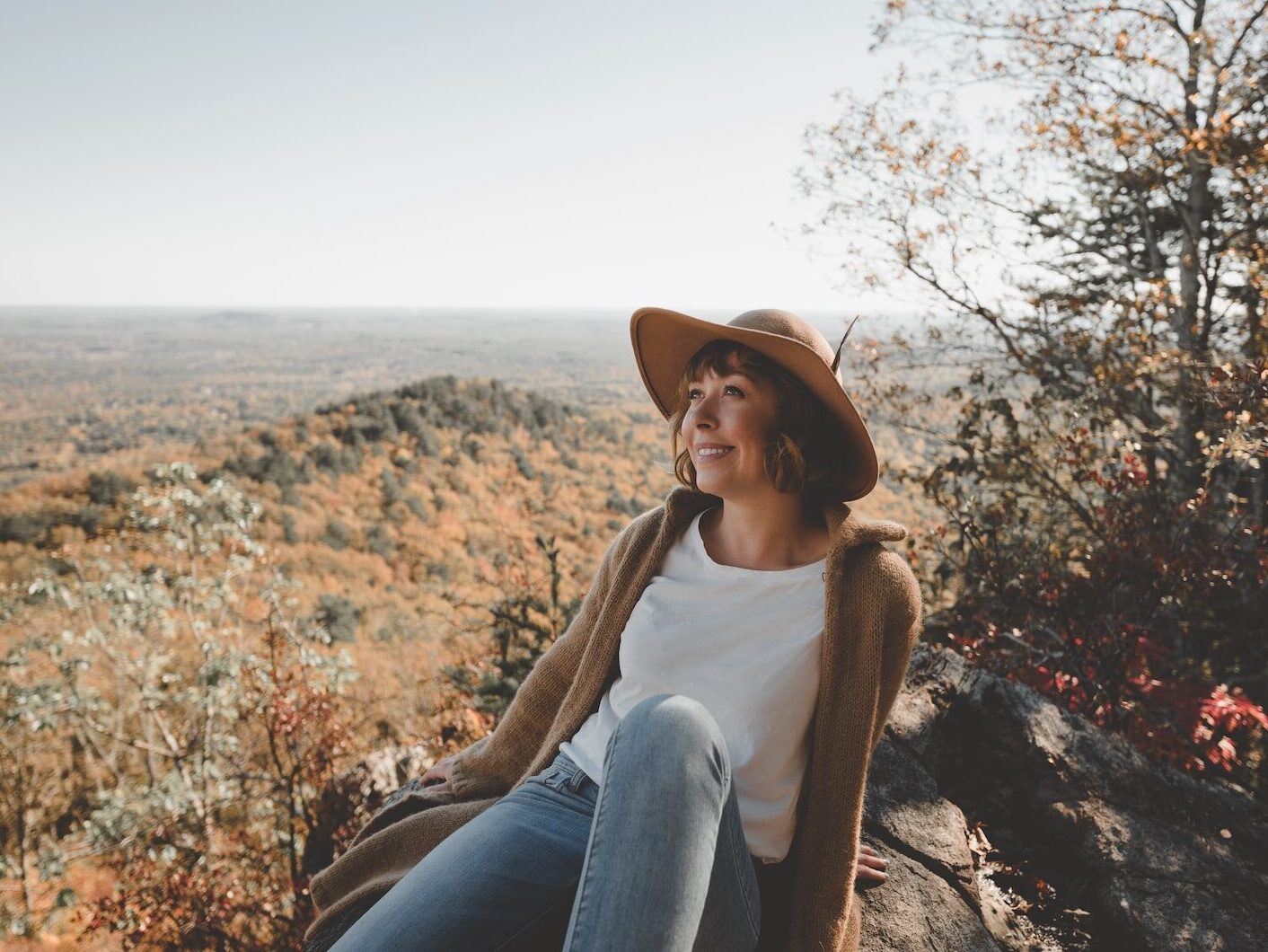 woman sitting on rock