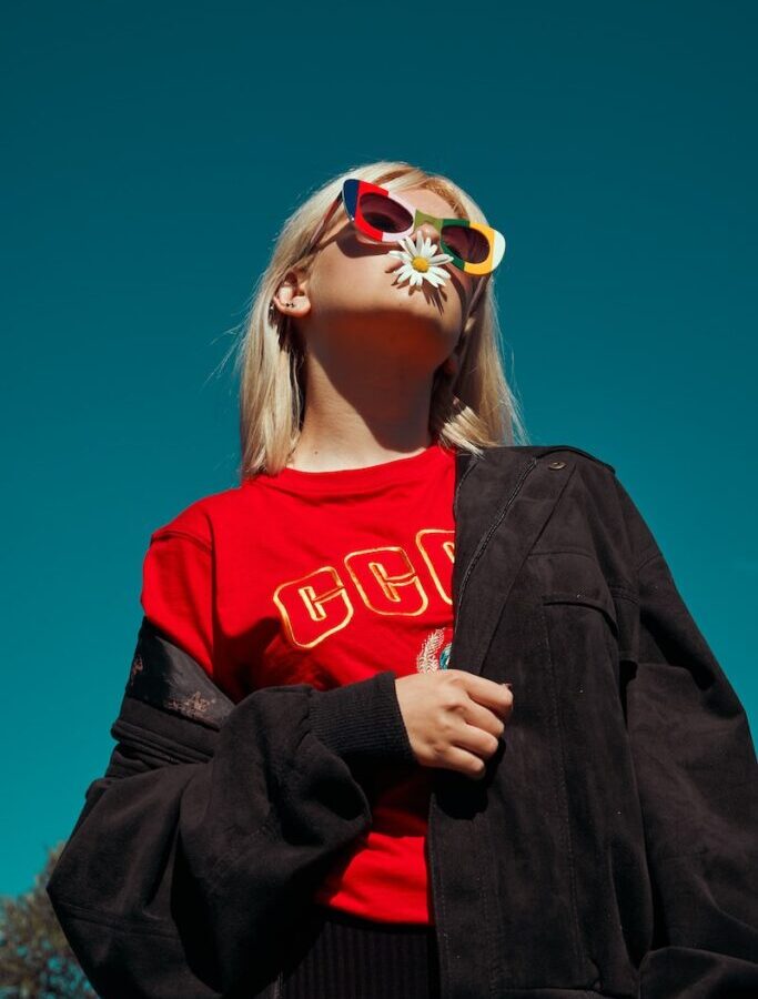 woman with sunglasses standing outdoor during daytime