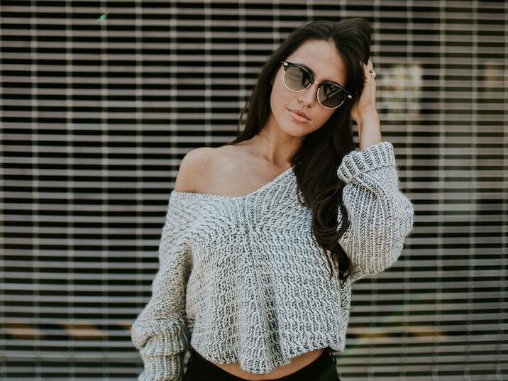 woman holding her head while standing