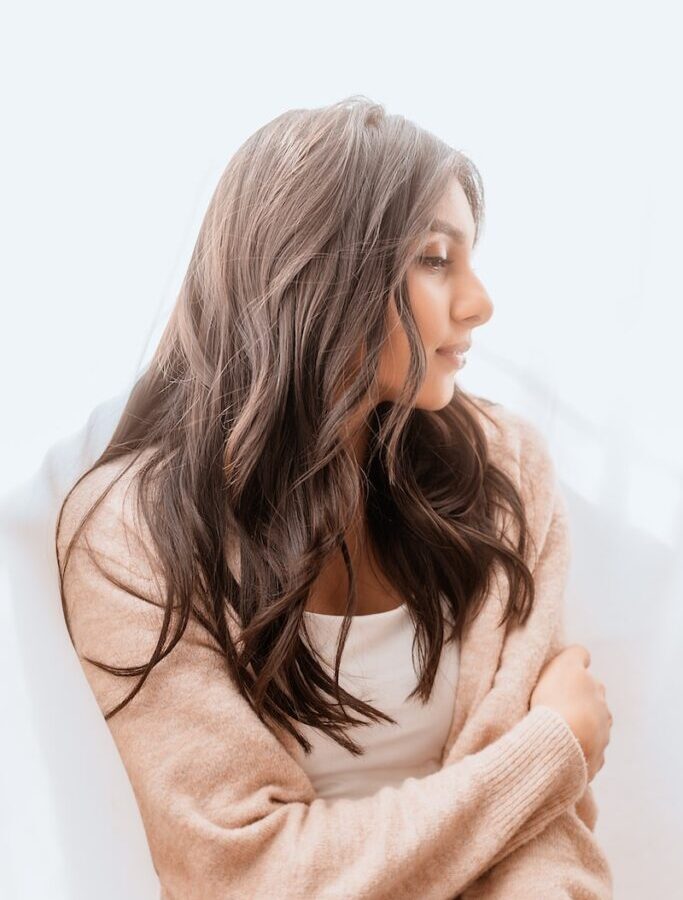 woman in white sweater smiling