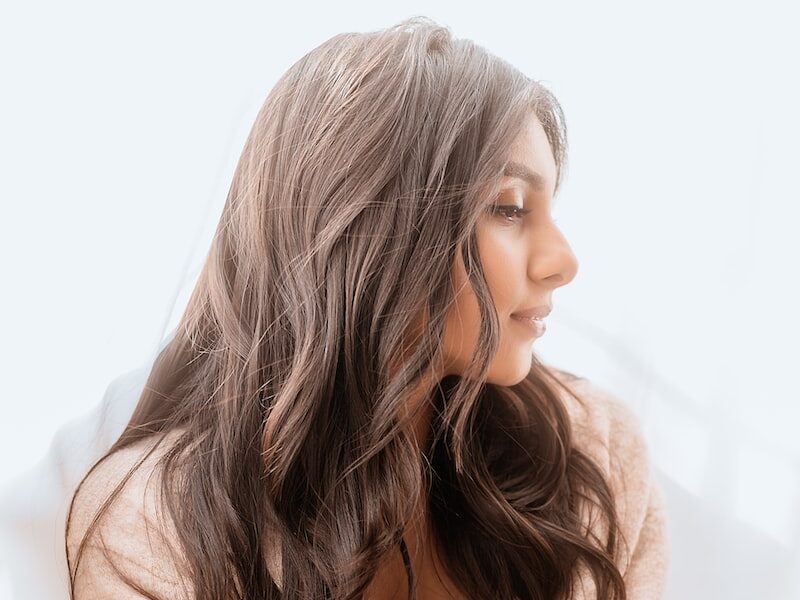 woman in white sweater smiling