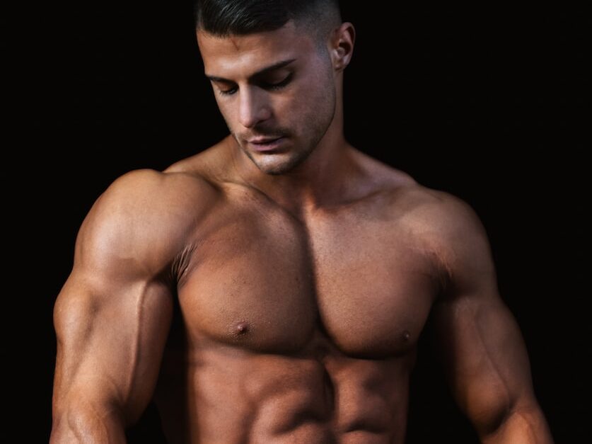 topless man wearing black pants