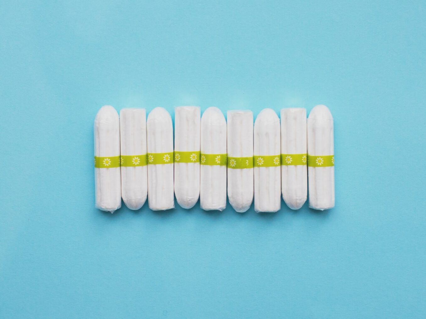 white oval medication pill on teal surface