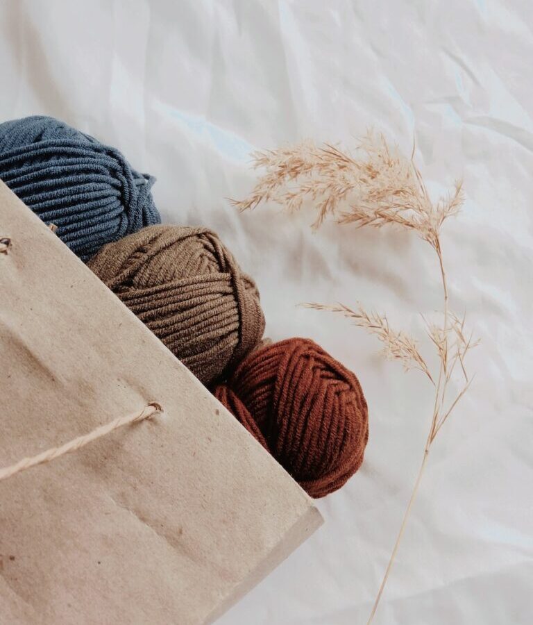 blue, brown, and orange yarn threads