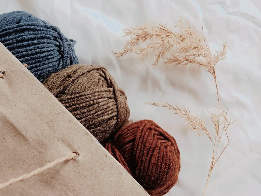 blue, brown, and orange yarn threads