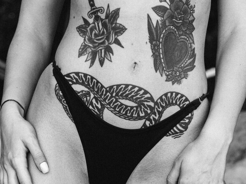 woman in black bikini bottom with tattoo on her back