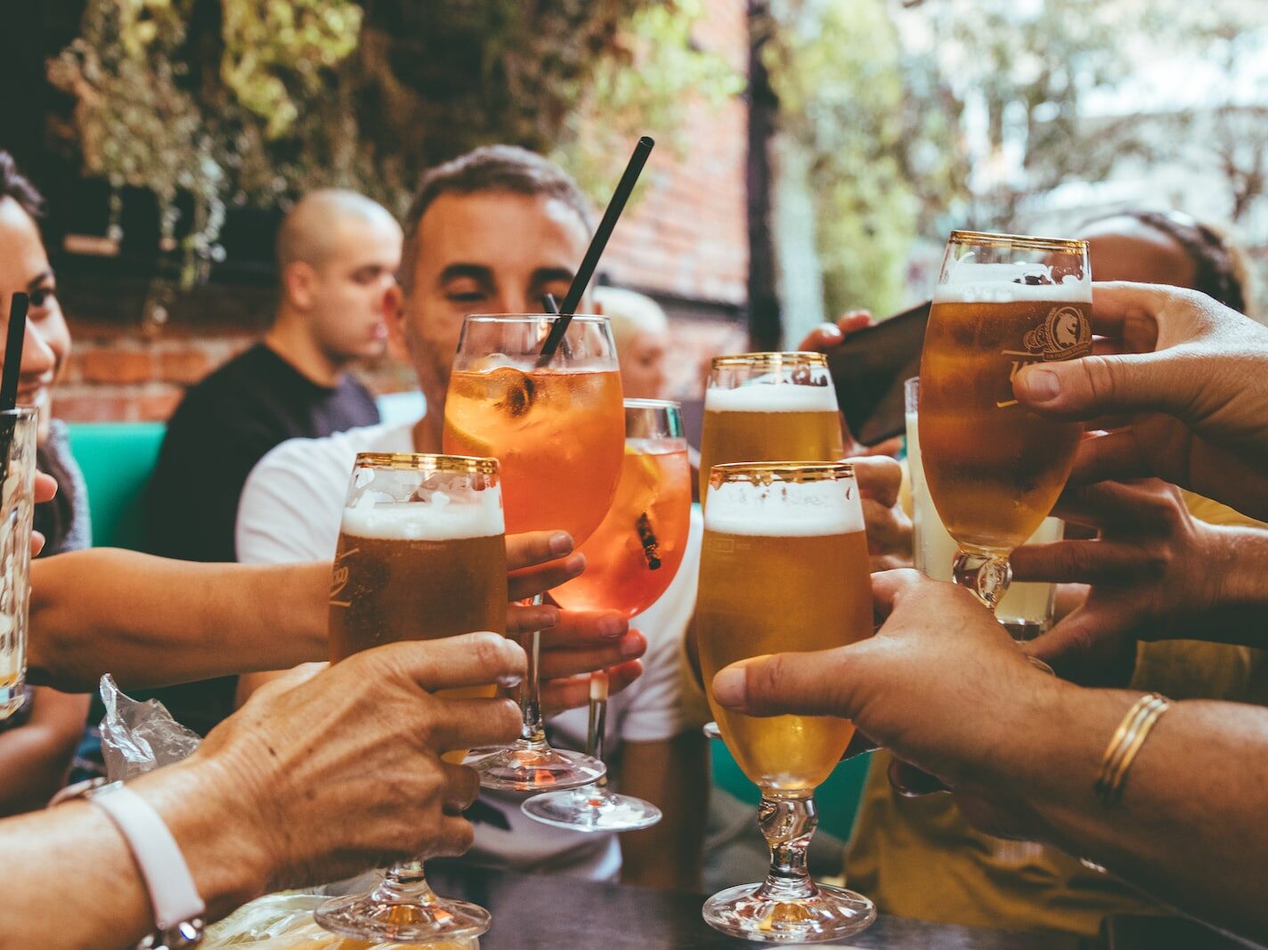 people holding drinks during day