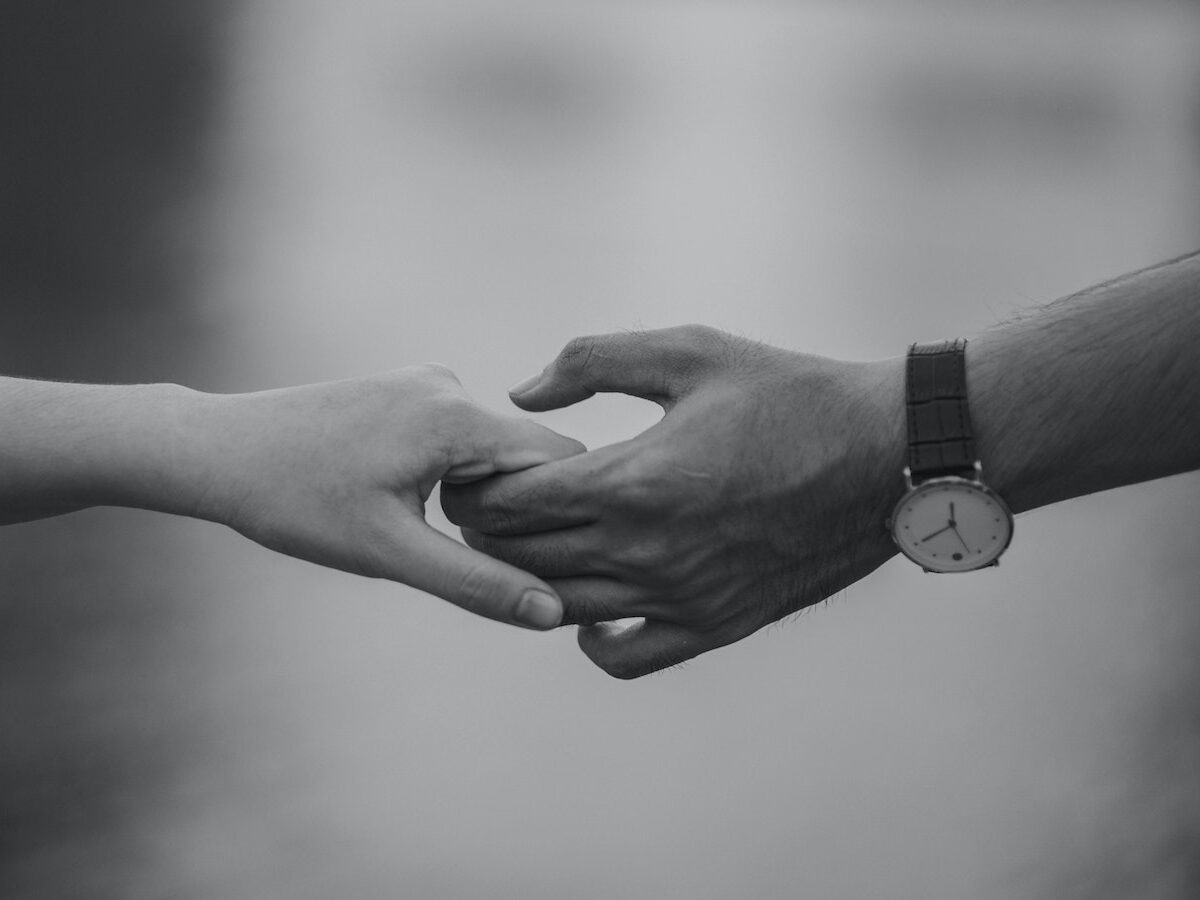 Monochrome Photo of Couple Holding Hands