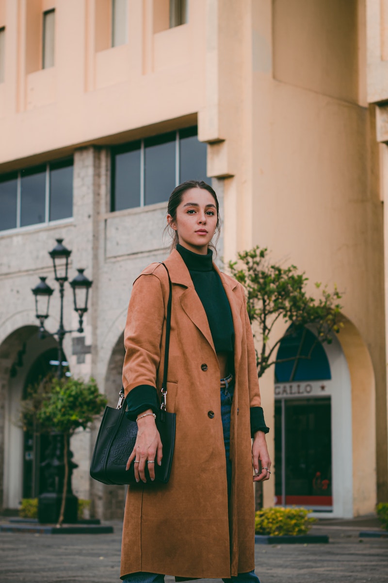 Woman in a Brown Coat Posing in City 