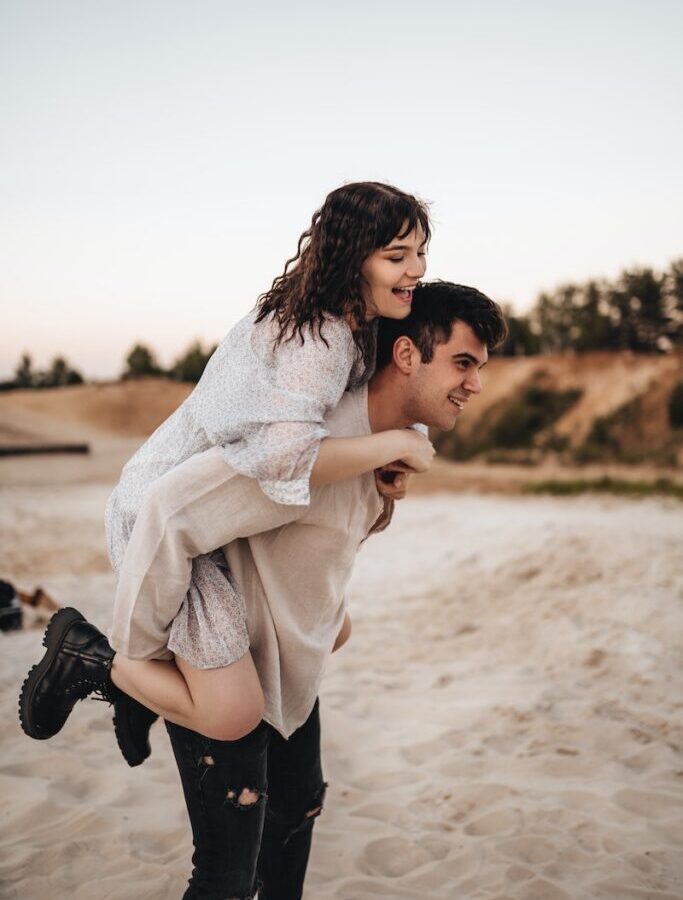 Woman in White Scarf and Black Boots Carrying Baby in White Sweater