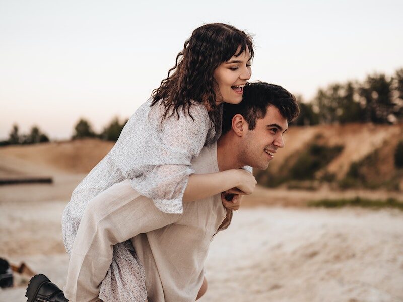 Woman in White Scarf and Black Boots Carrying Baby in White Sweater