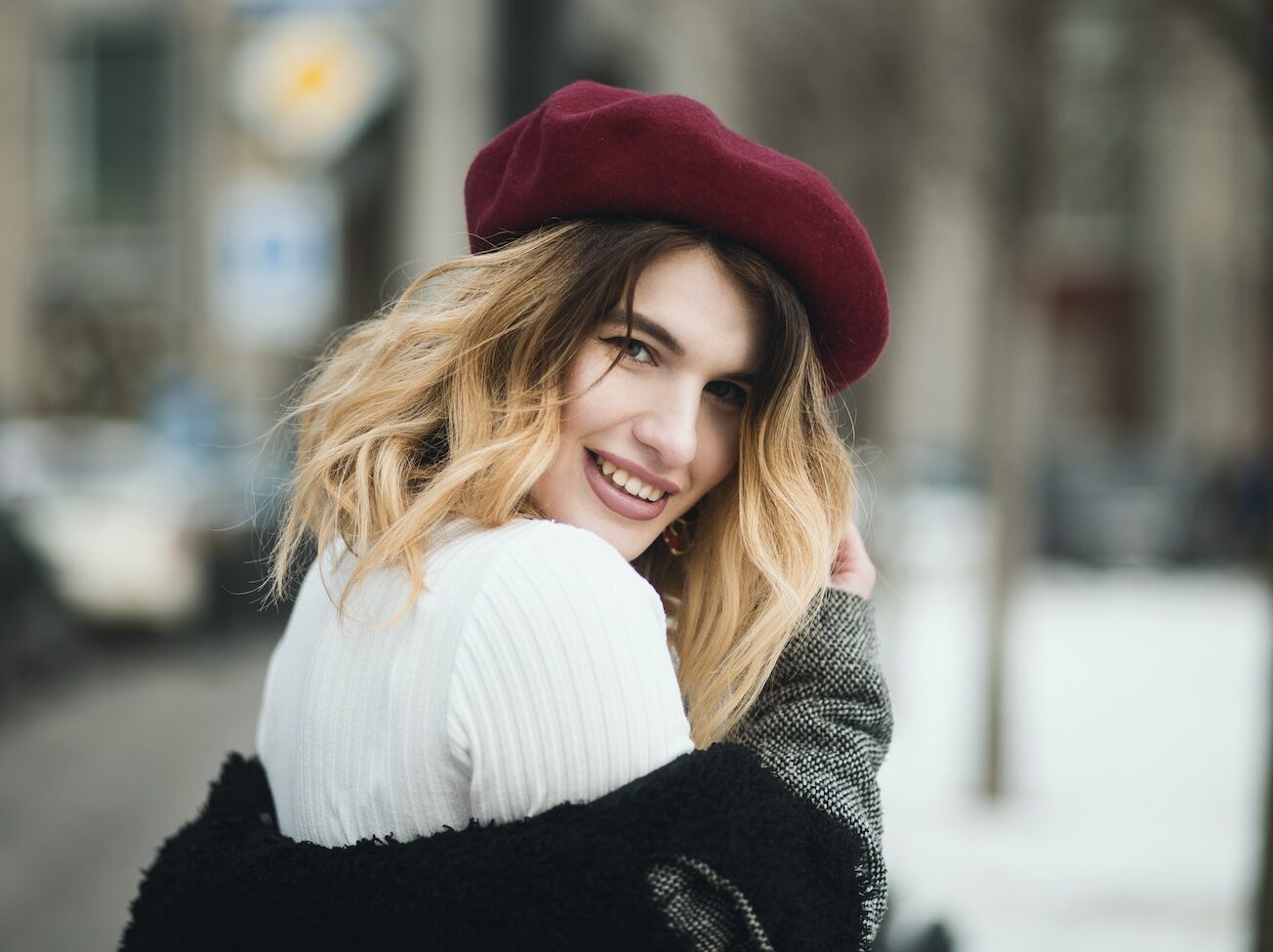 Selective Focus Photography of Smiling Woman Wearing Red Hat during Snowy Day
