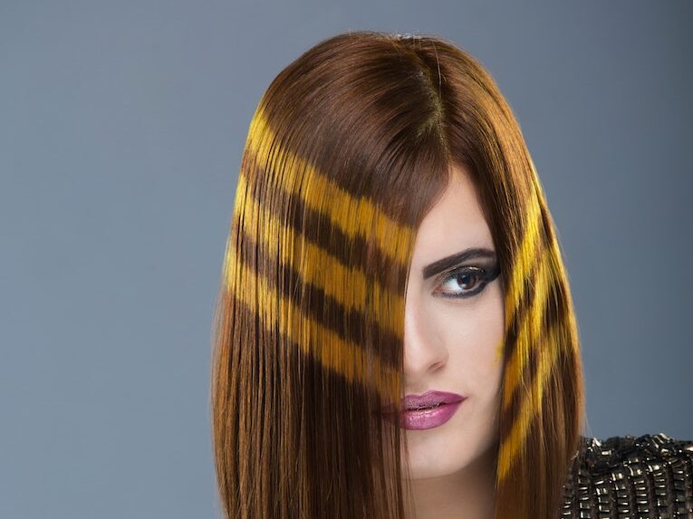 Woman With Brown Hair With Black Top With Gray Background