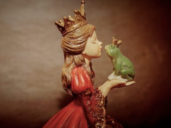 Woman Wearing Crown Holding Frog Figurine