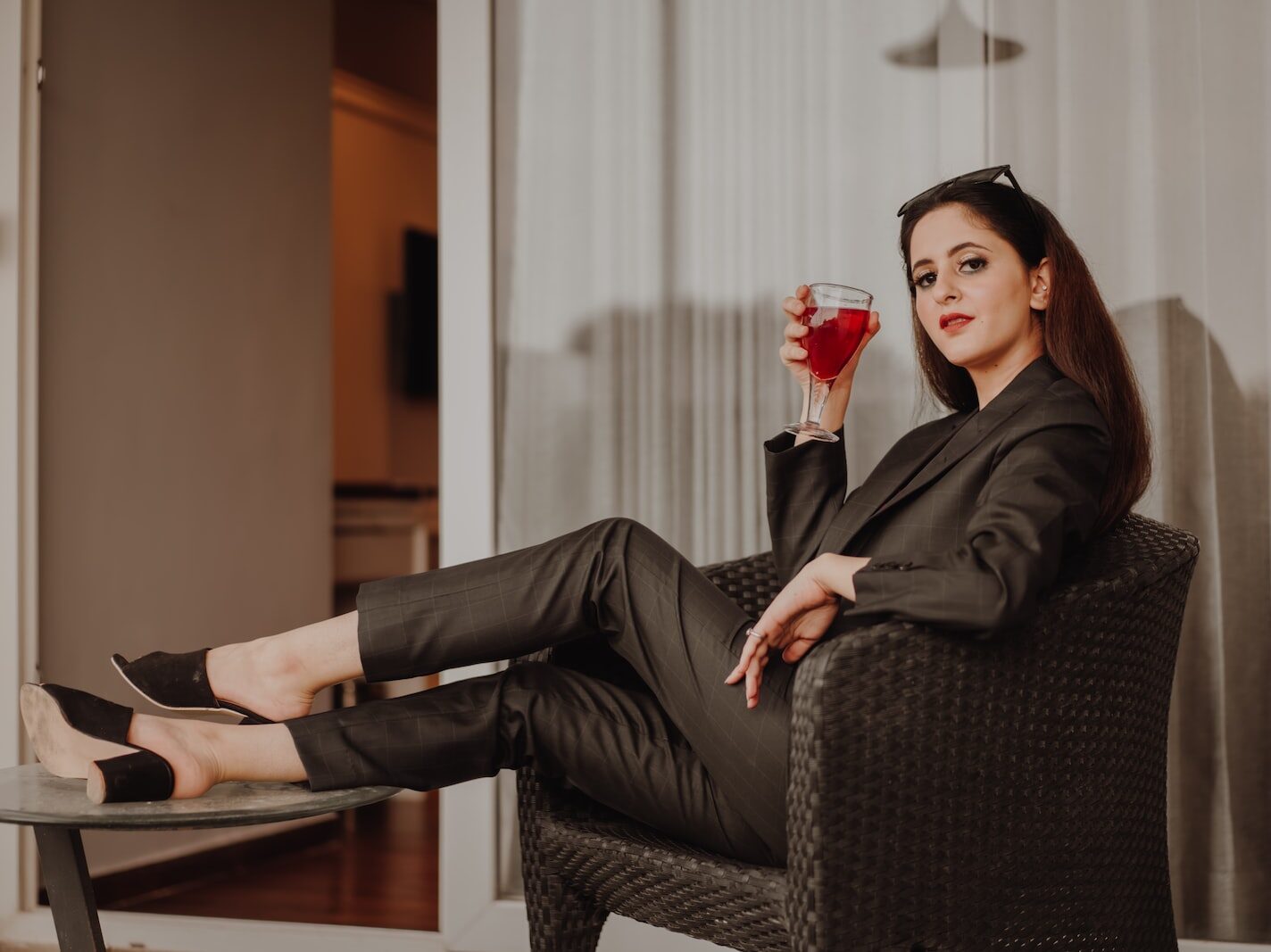 woman in black long sleeve shirt sitting on black and gray armchair