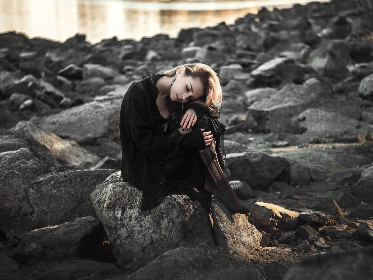 Woman Sitting on Rock