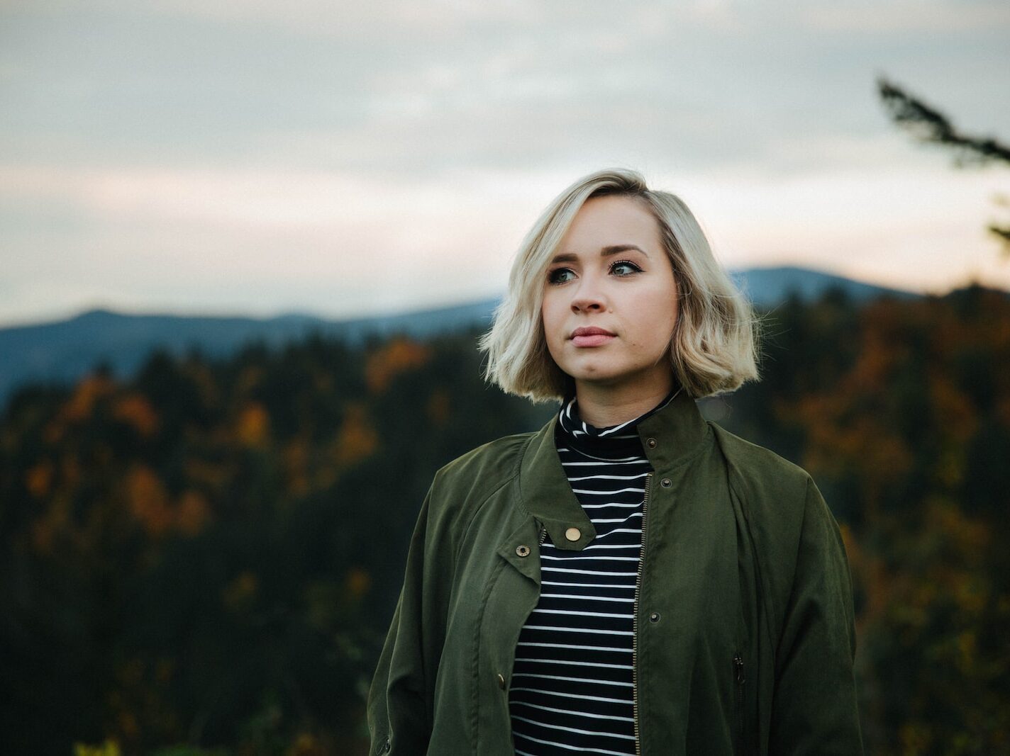 woman standing on top of mountain