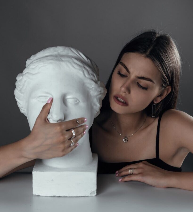 Young woman with bust sculpture