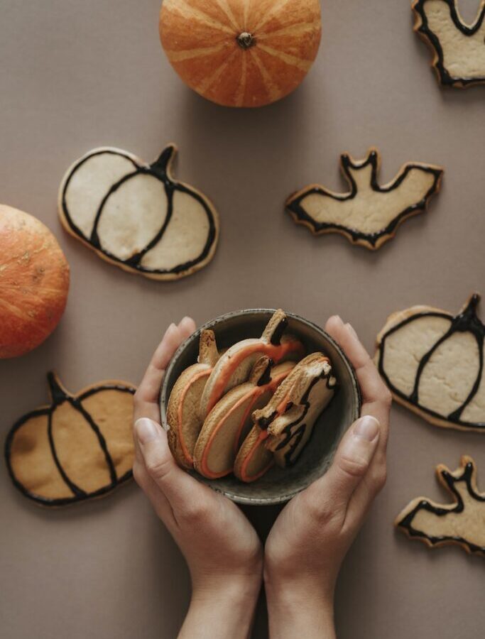 A Person Holding a Bowl of Halloween Cookies
