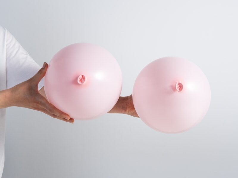 A Person Holding Pink Balloons