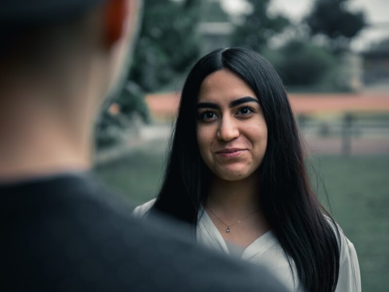 woman in black blazer smiling
