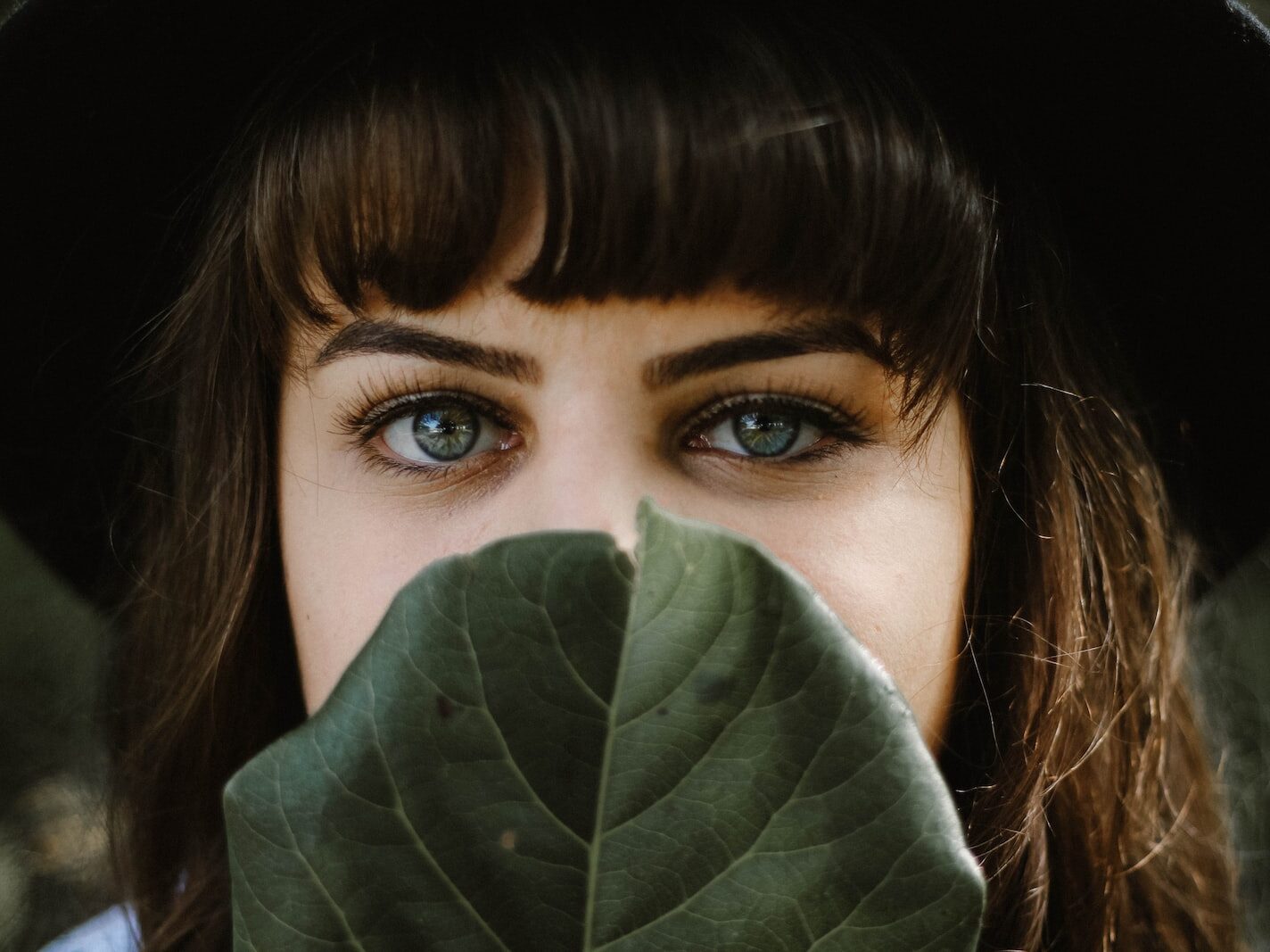 women beside green leaf
