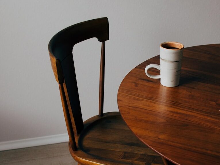 white ceramic mug on brown wooden table
