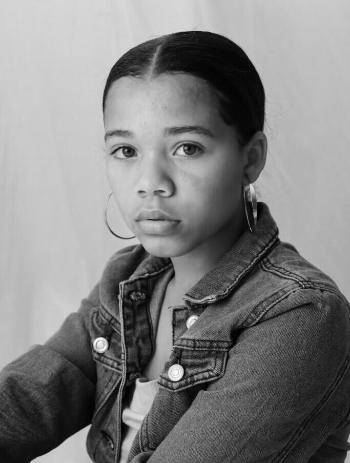 grayscale photo of boy in denim jacket