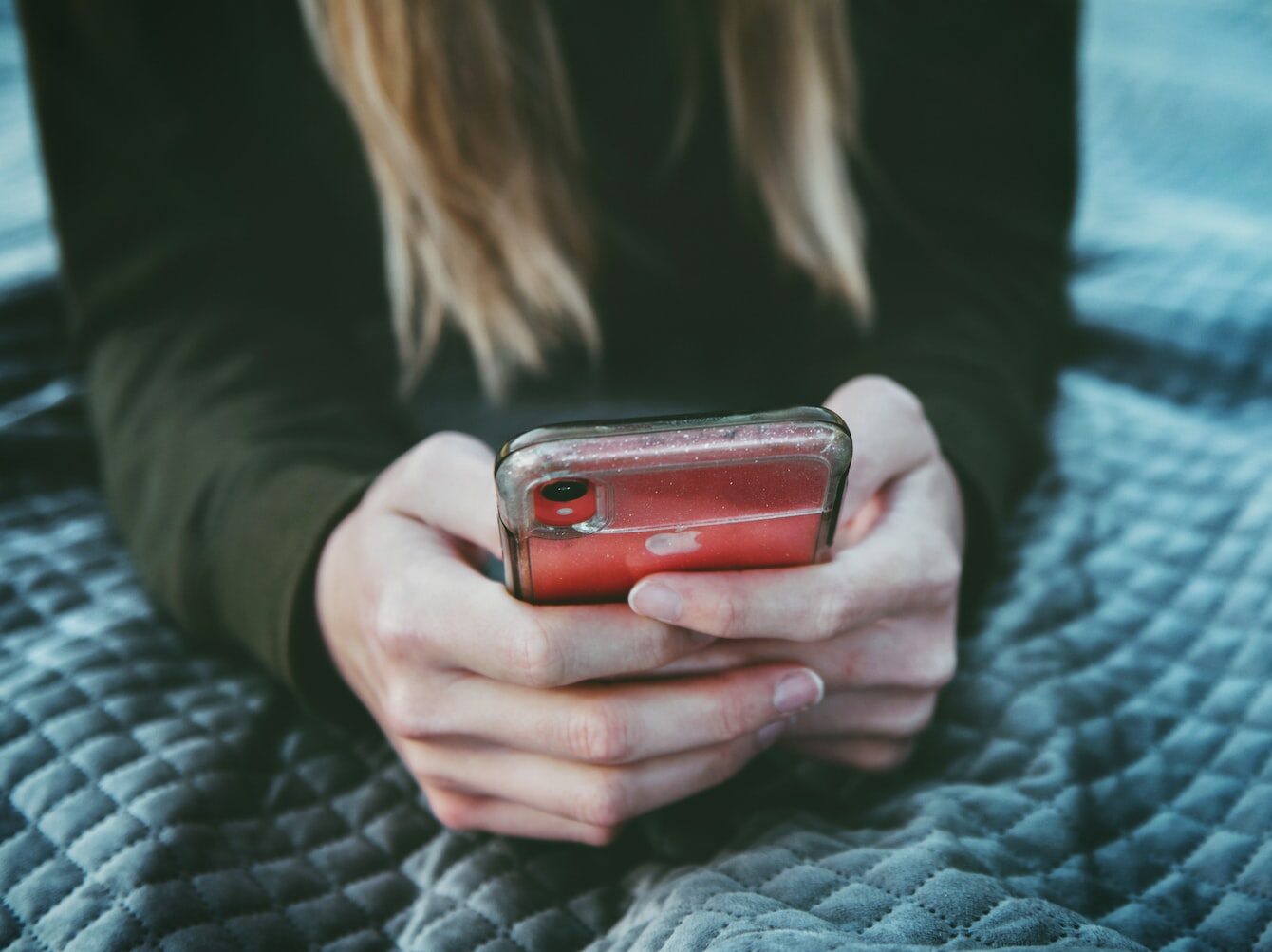 woman holding red and silver can