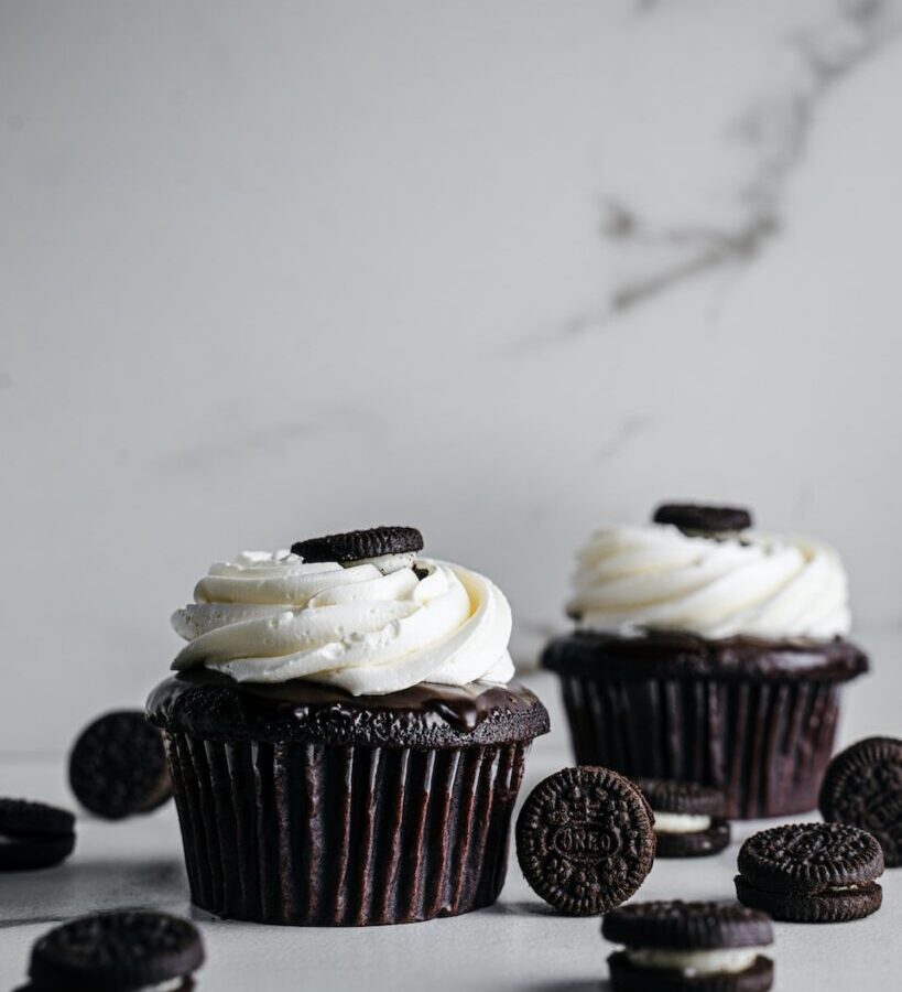 white and brown cupcakes on white table