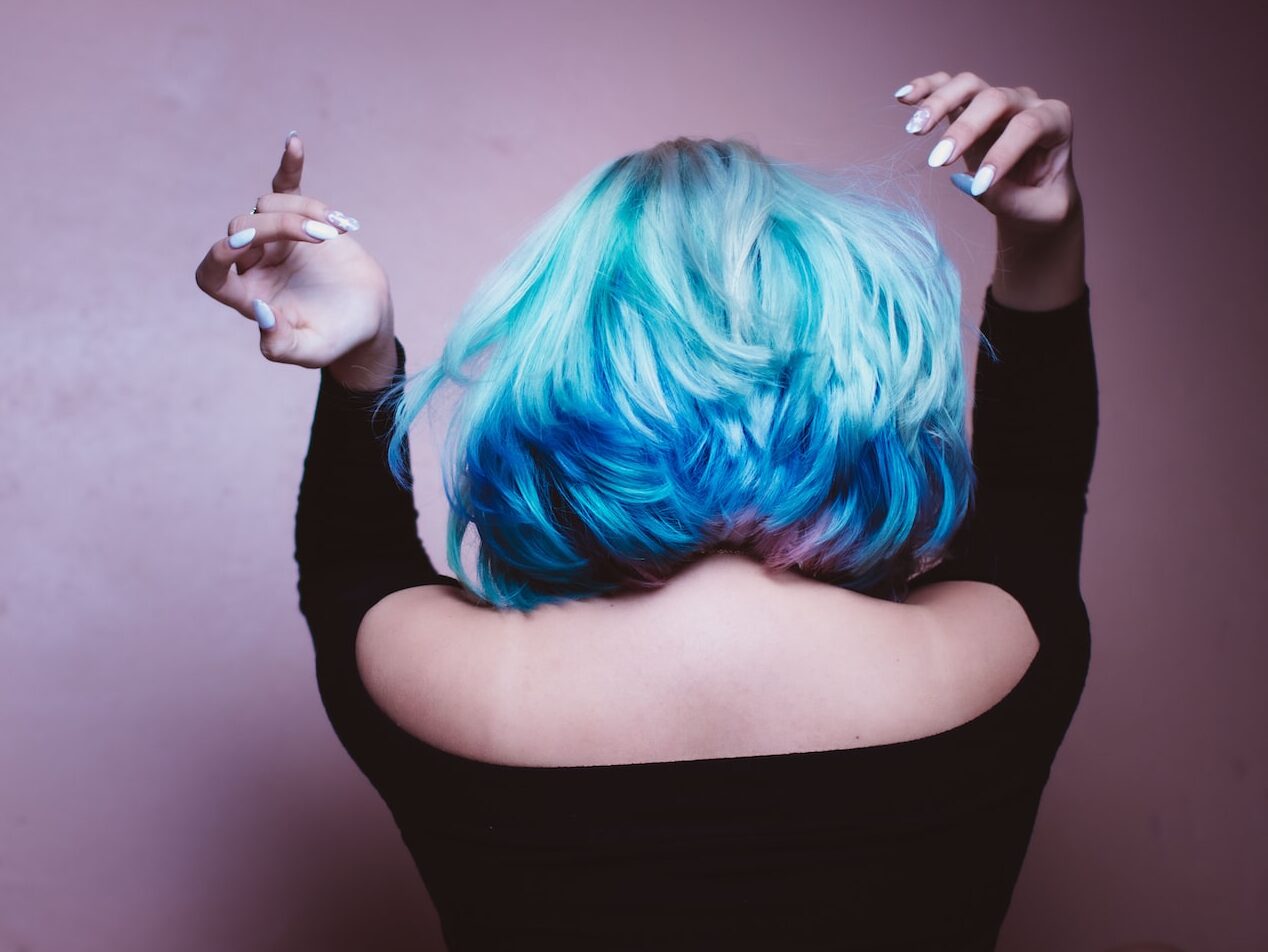woman facing backward with blue hair