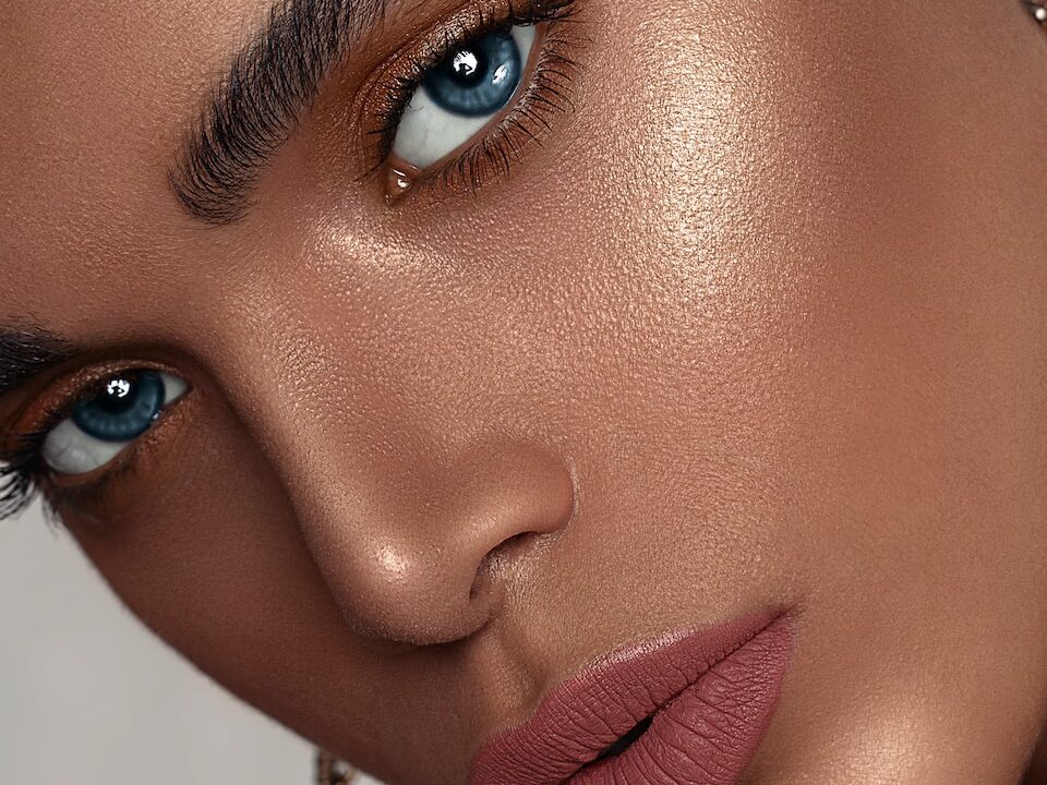 woman with red lipstick and gold hoop earrings