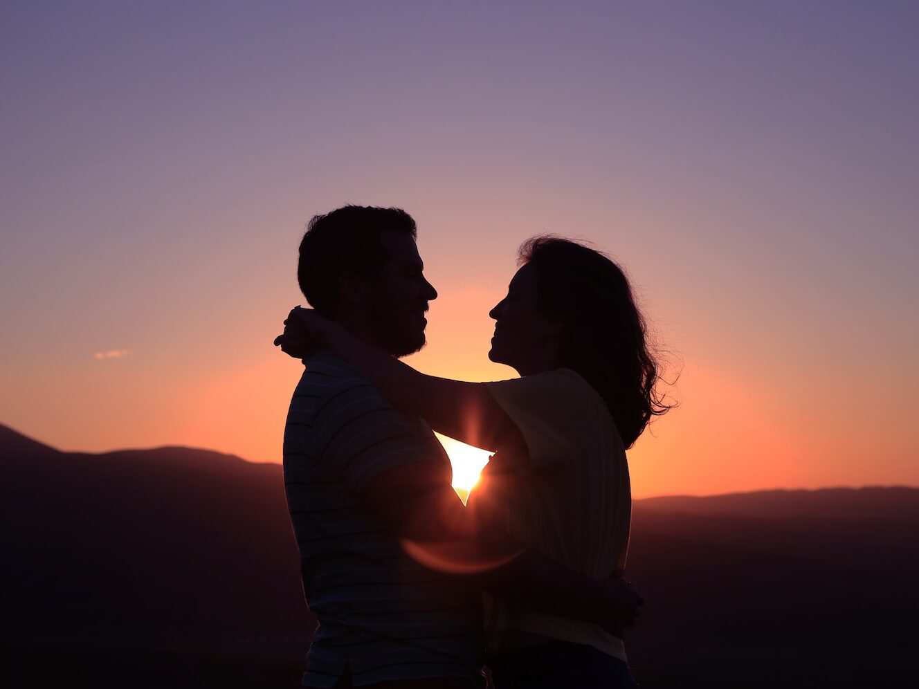 silhouette of hugging couple