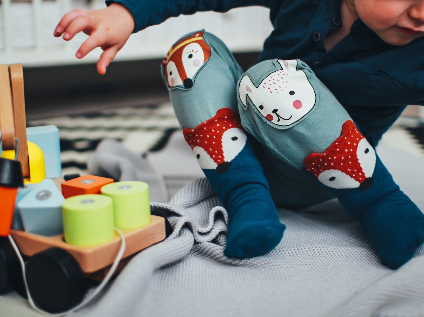 baby boy wearing pair of blue socks