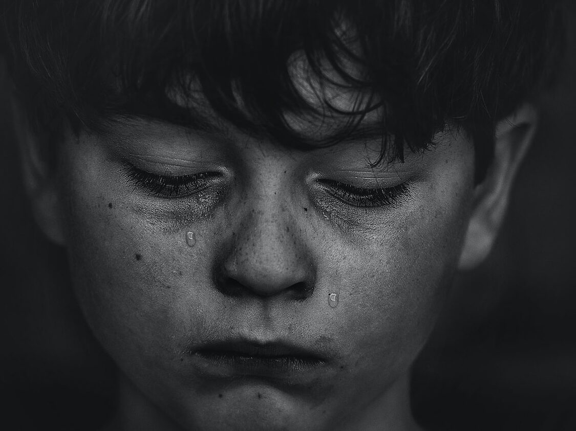 a boy crying tears for his loss