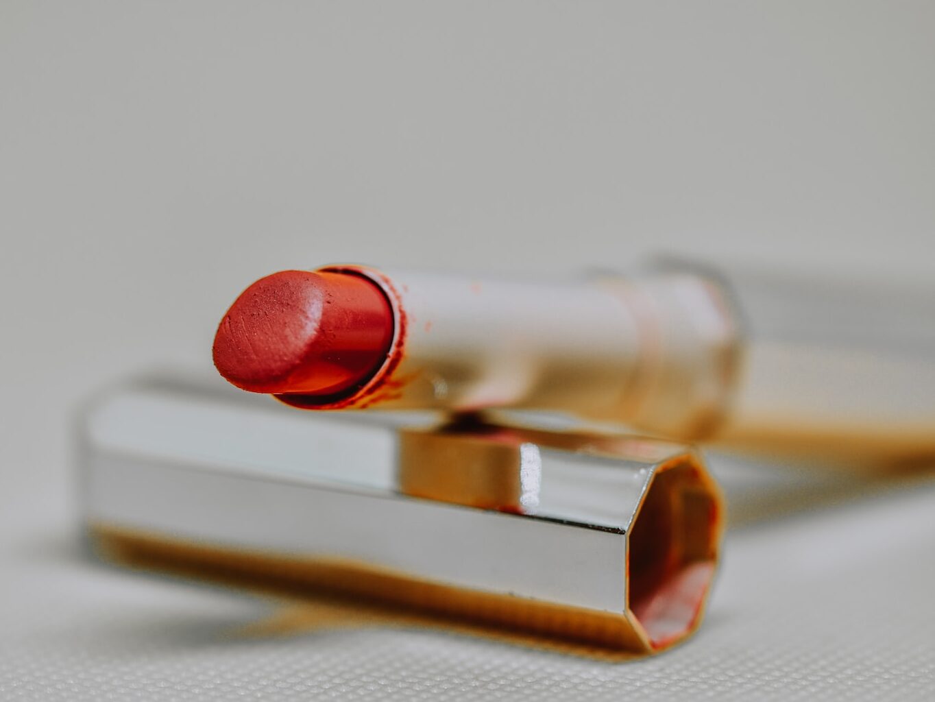 red lipstick on brown wooden table